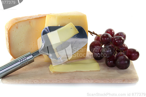 Image of Cheese with a cheese slicer