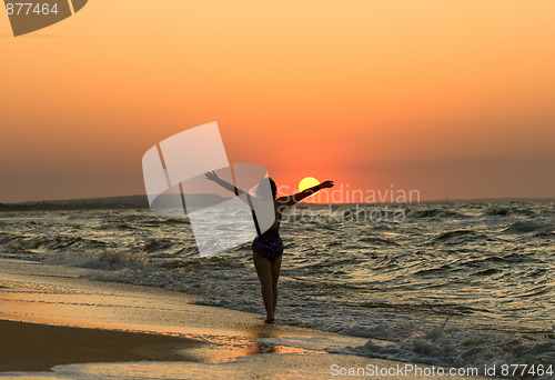 Image of Young woman in a sunset