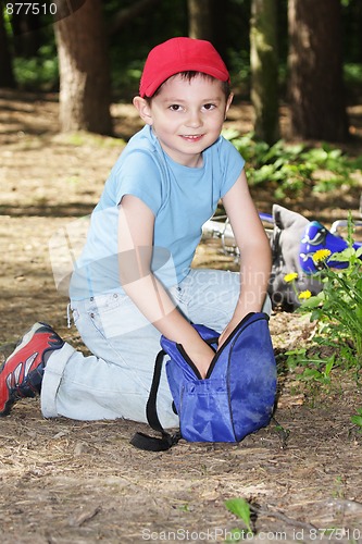 Image of Boy digging in bag