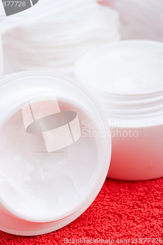 Image of facial cream and cotton pads
