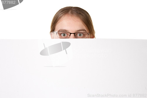Image of business woman peering over white sign