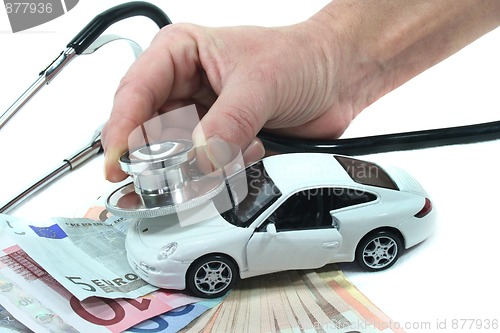 Image of Stethoscope with car and money