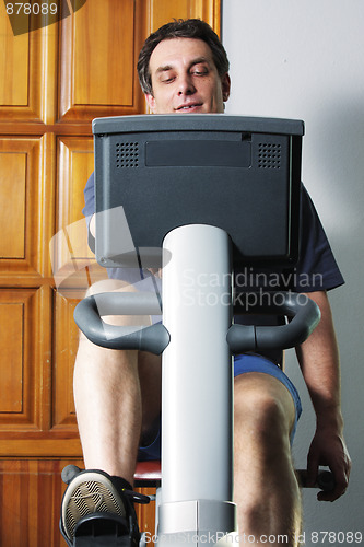 Image of Man on bicycle machine