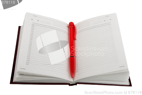 Image of Empty open diary and red ball point pen.