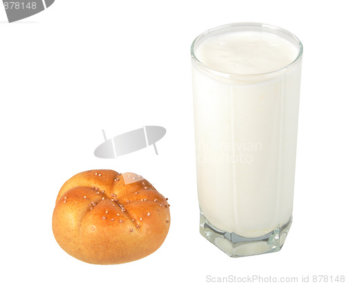 Image of Milk in transparent glass and yellow-orange bagel.