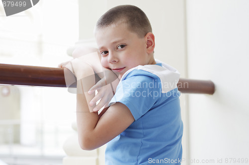 Image of Boy standing at banister closeup