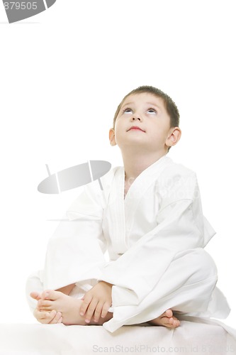 Image of Little karate kid legs crossed looking up
