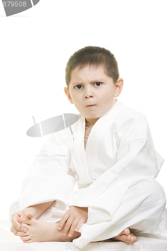 Image of Little displeased karate kid legs crossed