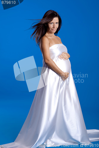 Image of Beautiful pregnant woman posing over a blue background
