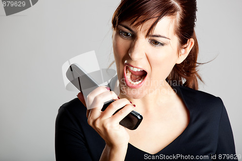 Image of Unhappy woman at cellphone