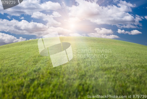 Image of Green Grass Field, Blue Sky and Sun