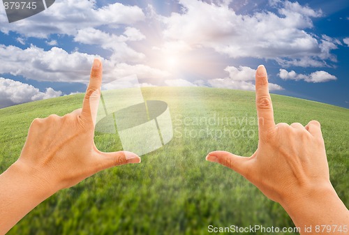 Image of Female Hands Making a Frame Over Grass and Sky