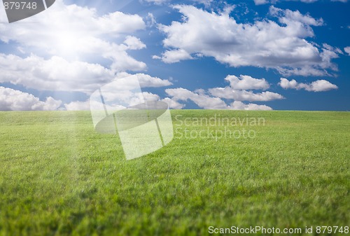 Image of Green Grass Field, Blue Sky and Sun