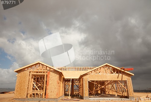 Image of Abstract Home Construction Site and Ominous Clouds