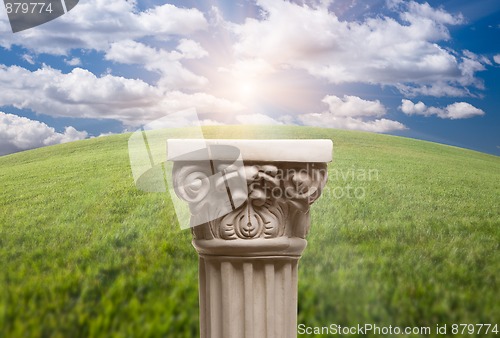 Image of Ancient Replica Column Pillar Over Grass and Clouds