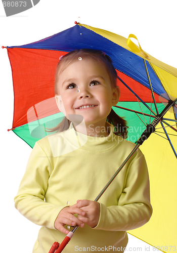 Image of Cute child catching raindrops under umbrella