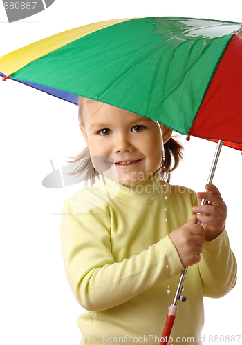 Image of Cute child catching raindrops under umbrella