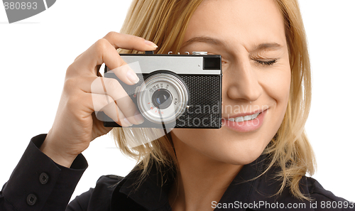 Image of young woman taking a shot with photo camera