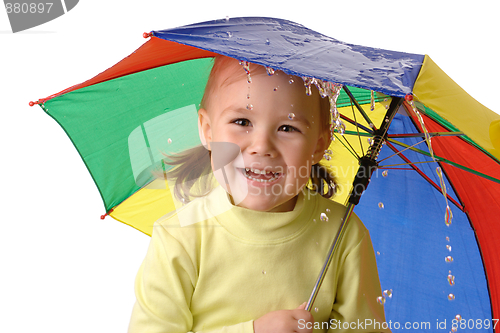 Image of Cute child catching raindrops under umbrella