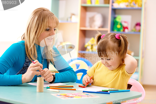 Image of Teacher with child in preschool