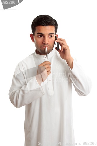 Image of Worried ethnic man on phone