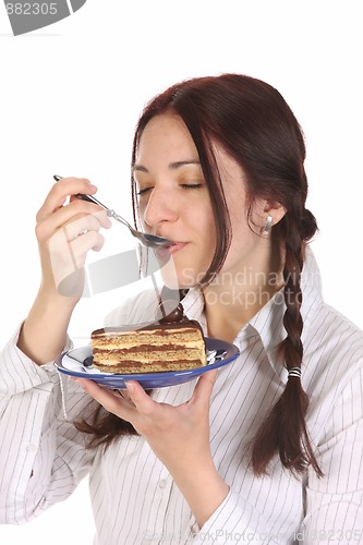 Image of Beautiful woman eating piece of cake