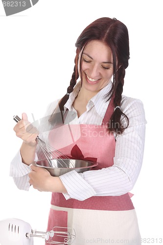 Image of beautiful housewife preparing with egg beater 