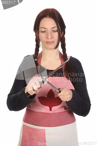 Image of housewife sharpening a knife