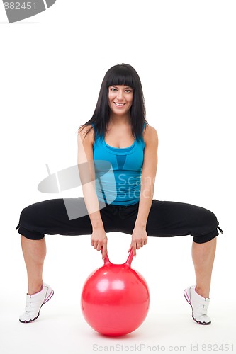 Image of Young happy woman exercise with sport ball