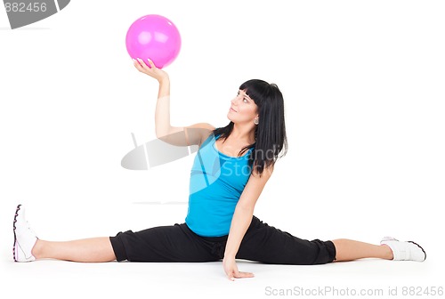 Image of Woman exercise with ball doing splits