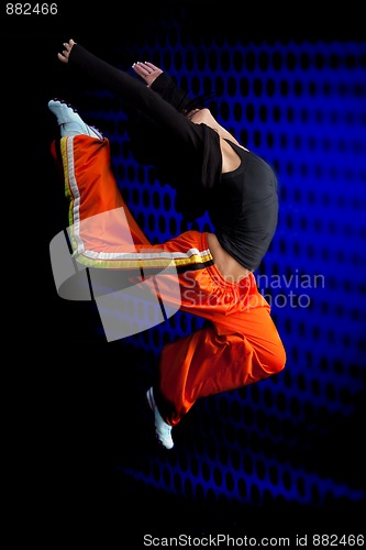 Image of Dancer jumping on dark background