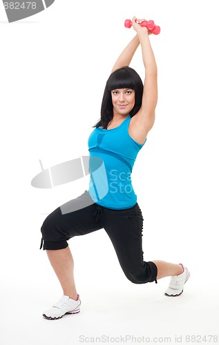 Image of Young positive woman exercise with dumbbells