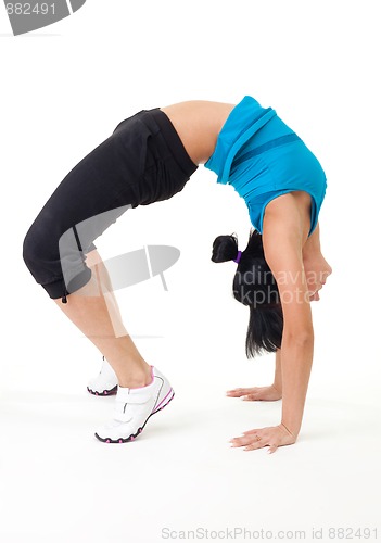 Image of Woman holding bridge stretching pose