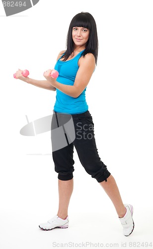 Image of Young woman do fitness using dumbbells