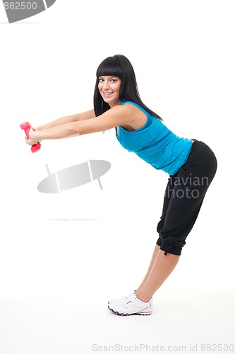 Image of Woman stretching with dumbbells