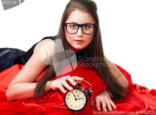 Image of Attractive girl with alarm clock