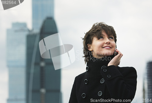 Image of Smiling woman in black on cellphone