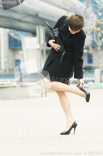 Image of Woman adjusting shoe