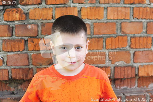 Image of Boy at brick wall