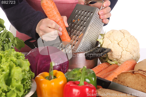 Image of cutting carrot with stainless grater