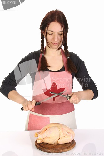 Image of housewife sharpening a knife with sharpener 