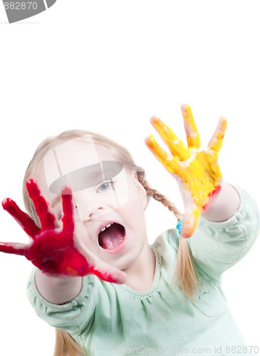 Image of Little girl playing with colors