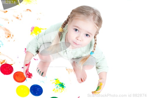 Image of Little girl playing with colors