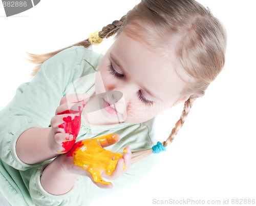 Image of Little girl playing with colors