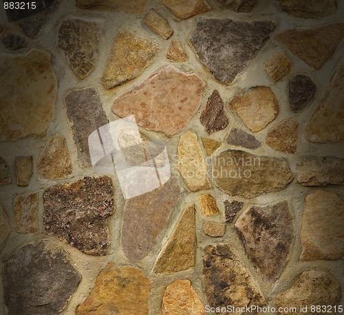 Image of Masonry wall with irregular stones lit from above