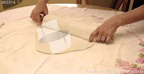 Image of Hands with rolling pin preparing pastry