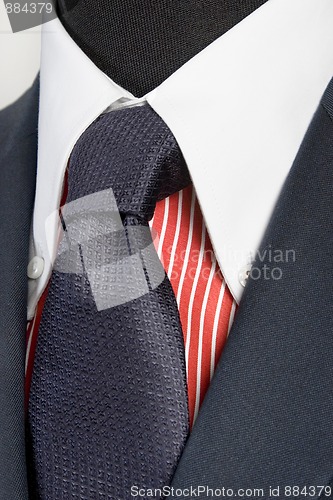 Image of blue suit with tie and red striped shirt