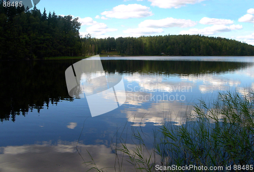 Image of White clouds are floating in water of wood lake