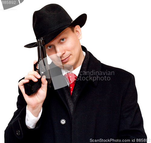 Image of Man in suit, red tie with gun