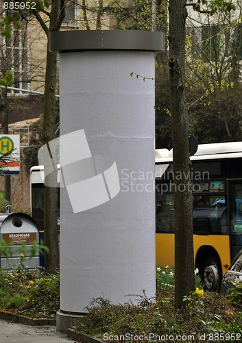 Image of City scenery - advertising pillar with traffic